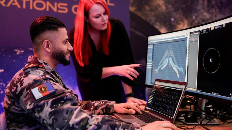 Able Seaman Qambar Said with US Space Force personnel working at the Commercial Operations cell, Adelaide. 