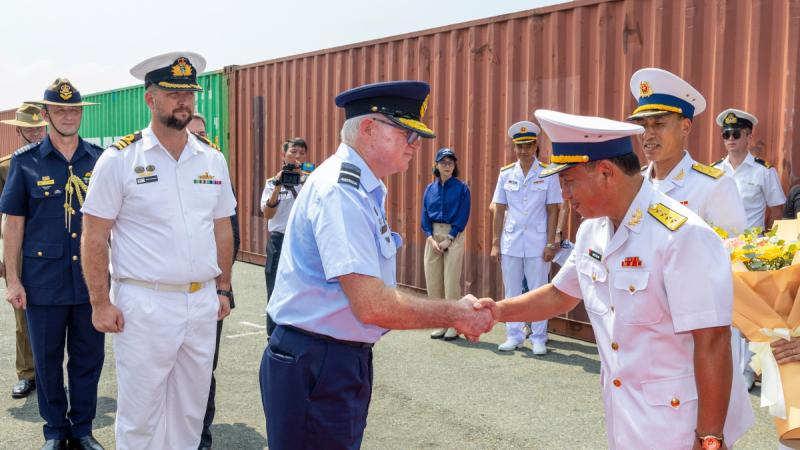 Commander Indo-Pacific Endeavour Air Commodore Tony McCormack shakes Senior Captain Nguyen Viet Anh's hand during the arrival of HMAS Toowoomba in Ho Chi Minh City.