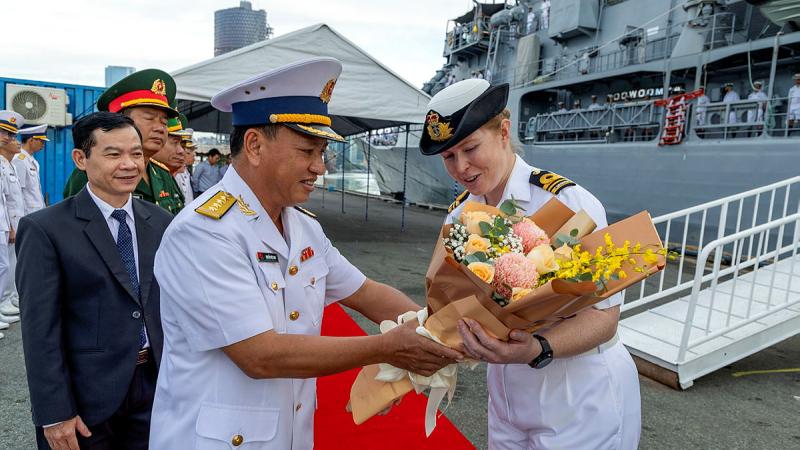 Lieutenant Commander Emily Ross accepts flowers from Vietnam People's Navy Captain Ngyuen Viet Ahn during HMAS Toowoomba's departure ceremony at Ho Chi Minh City, Vietnam, as part of Indo-Pacific Endeavour. Photos: Leading Seaman Ernesto Sanchez