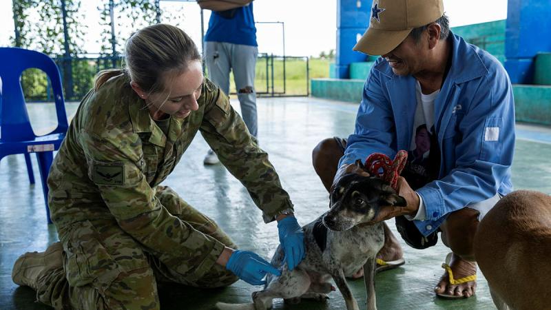 Australian Army veterinarian Captain Naia Knight administers a rabies vaccine to a local community member’s pet at a vet civic action program in the regional community of Rio Chico, Philippines.