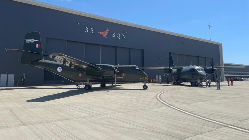 A DHC-4 Caribou aircraft, left, sits beside a C-27J Spartan aircraft from 35 Squadron at RAAF Base Amberley, Queensland.