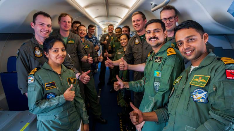 Members of the Indian Navy and Royal Australian Air Force stand inside a Royal Australian Air Force P-8A Poseidon at Indian Naval Air Base Rajali during Indo-Pacific Endeavour 23.