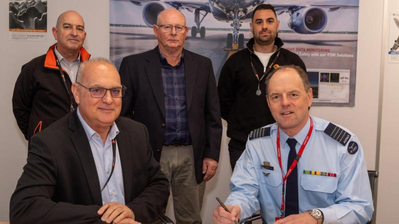 Managing Director Aerodynamic Darren Privitera, front left, and Officer Commanding Air Training and Aviation Commons Group Captain Russell Box, front right, during a ceremonial signing of contract with, from back left, Robert Gobaira, Kevin Kues-Sales and Keelan Privitera. 