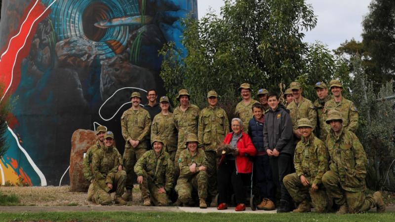 Signallers from 144 Signal Squadron and 108 Signal Squadron stand with their local aboriginal guides during a community engagement in Haywood, Victoria.