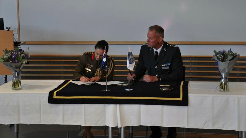  Australia’s Defence Attaché to Northern Europe, Colonel Lisa Weston signs the Letter of Accession before Commandant Nordic Centre for Gender in Military Operations, Swedish Armed Forces Lieutenant Colonel Olov Kesselmark, to induct Australia as a partner nation. 