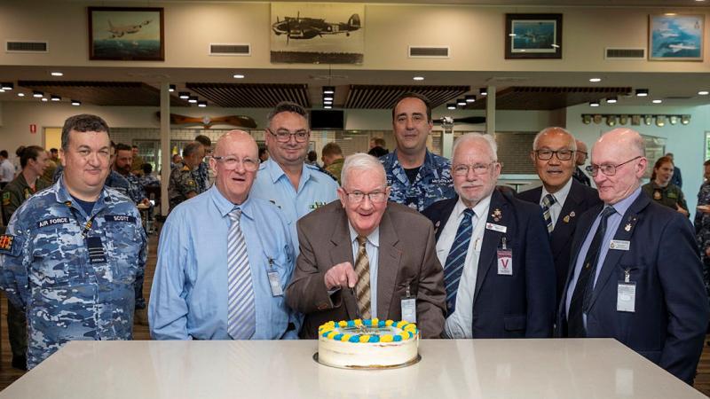 Centenarian and Bomber Command Veteran Angus Hughes cuts his birthday cake with veterans Group Captain Greg Weller and members of 462 Squadron at RAAF Base Edinburgh. 