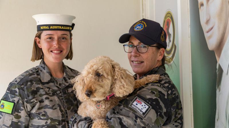 Recruit Cassandra Kelly, left, and Recruit School Petty Officer Deborah Barthelson with her dog, Molly, at HMAS Cerberus Recruit School, Melbourne.