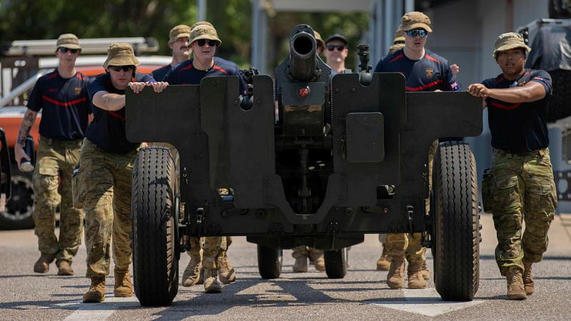 Soldiers from the 8th/12th Regiment, Royal Australian Artillery push a 2500kg M2A2 howitzer on a 20km journey through Darwin City to raise funds for the Gunner Bear charity. 