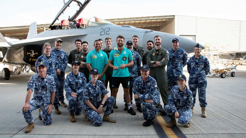 Brisbane Heat cricket players Usman Khawaja and Michael Neser with RAAF aviators.