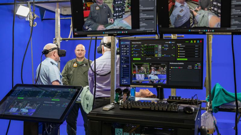 Commander Combat Support Group, Air Commodore Robert Graham (Left) and Combat Support Group Sustainment Enterprise Manager, Brett Kleidon experience the new 'Blue Room' virtual trainer.