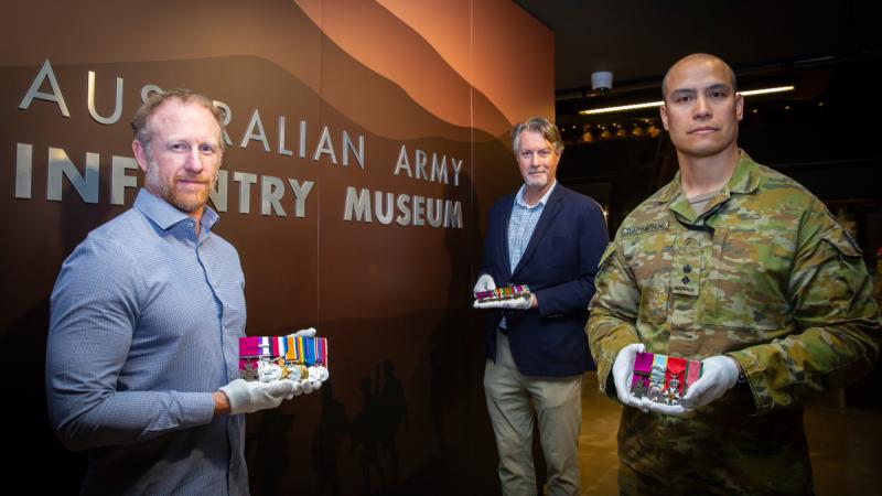 (l-r) Australian VC recipient Army Corporal Mark Donaldson VC, Mr Tim Gellel, head of Army History Unit, and Commanding Officer School of Infantry, Lieutenant Colonel Richard Thapthimthong hold a selection of the Victoria Crosses.