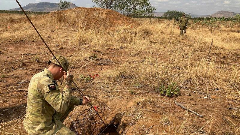 Explosive ordnance disposal technicians from Air Force's 65 Air Base Recovery Squadron conduct a subsurface survey during the Bradshaw Field Training Area.