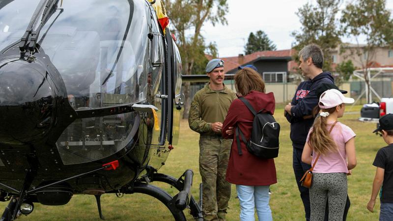  An officer from Australian Army 16th Aviation Brigade speaks to visitors about the EC-135 at the Randwick Barracks Open Day, Oct 28. 