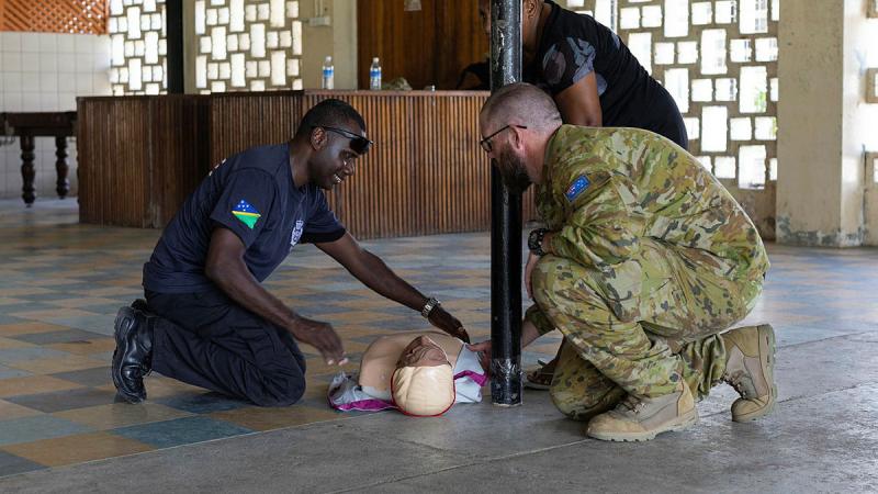 RAN Medic, Able Seaman Adam Favley assists a member of the RSIPF.
