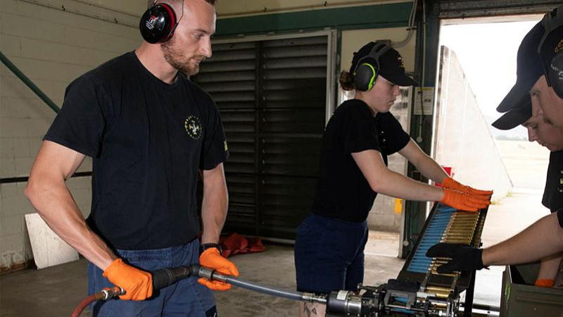 Armament Fitters from 1 Squadron, Leading Aircraftman Ethan Collingwood, left, and Aircraftwoman Hunter Glover, loading rounds into an ammunition loader at the bomb preparation area at RAAF Base Townsville during Exercise Black Dagger. 