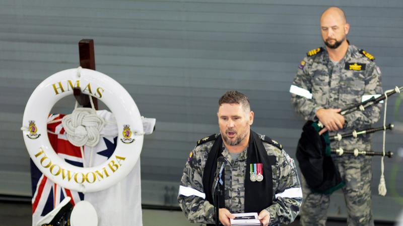 Navy Chaplain Bradley Galvin addresses HMAS Toowoomba ship’s company as they commemorate Remembrance Day in the East China Sea during a regional presence deployment.