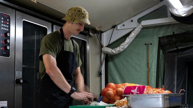 Australian Army cook, Private Aaron Blair prepares food for deployed personnel at the Camp Clark deployable kitchen at the Pacific Games 2023 in Honiara, Solomon Islands. 