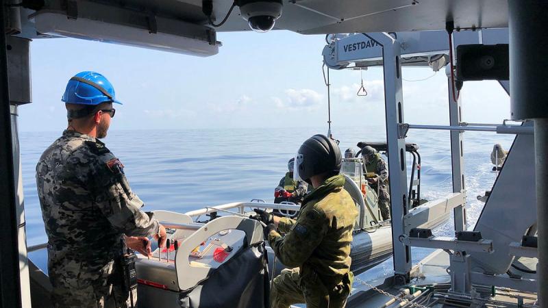 ADV Cape Capricorn's seaboat is safely recovered with the help of Private Crosher under the guidance of the Davit Operator, Leading Seaman Matthew Anderson.