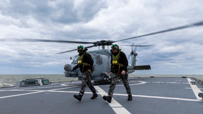 Leading Seaman Aviation Technician Avionics Kalani Brinkmeier (left) and Able Seaman Aviation Technician Avionics Samuel Speakman from HMAS Toowomba on the flight during flying operation as part of Operation Argos.