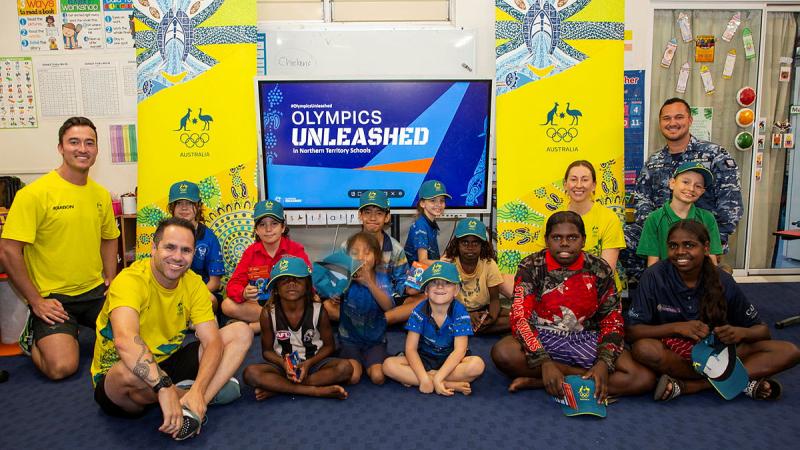 Past and present Australian Olympians and Leading Aircraftman Will Lauenstein (rear right) with students from the Mataranka School, NT.