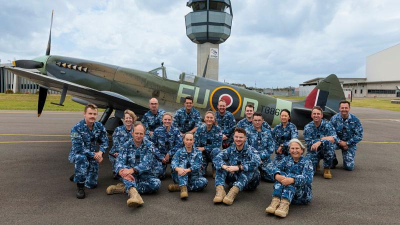  Personnel from 453 Squadron with a Supermarine Spitfire Mk XVI from 100 Squadron at RAAF Base Williamtown, NSW. Image has been digitally manipulated, 453 Squadron sign added to ATC tower. 