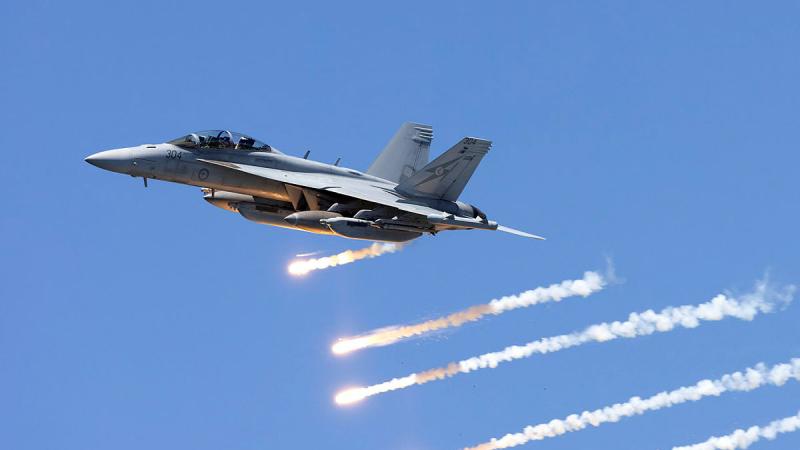 An Air Force EA-18G Growler aircraft dumps its flares during a handling display at Nobby's Beach during the Newcastle Williamtown Air Show. 
