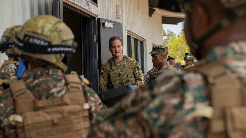 Soldiers from the 5th Battalion, The Royal Australian Regiment and the Timor-Leste Defence Force listen to a safety brief ahead of conducting an urban operations scenario at the indoor training facility at Robertson Barracks, NT. 