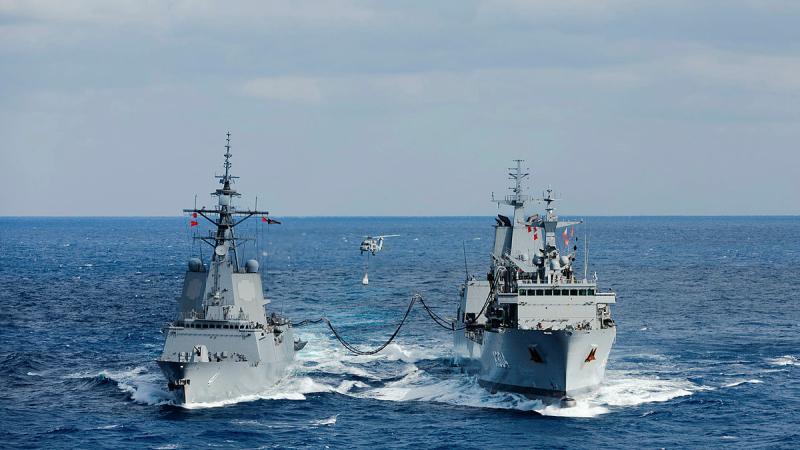HMAS Stalwart’s embarked MH-60R helicopter ‘Boomerang’ conducts a vertical replenishment while the ship conducts a replenishment at sea with HMAS Brisbane. 