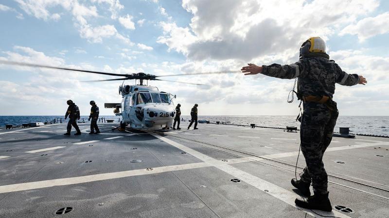Personnel from JS Sazanami’s embarked Super Auk helicopter on HMAS Brisbane.