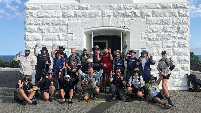 Navy members from HMAS Stirling having completed the 135km Cape to Cape trail arrive at Cape Leeuwin Lighthouse.