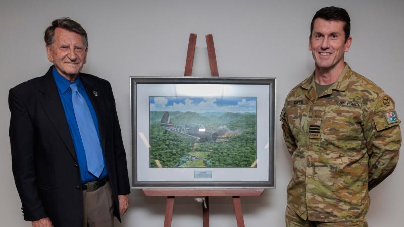 Garry Cooper and Commanding Officer 4 Squadron Wing Commander Steven Duffy unveil a painting commissioned by aviation artist Ivan Berryman at 4 Squadron, RAAF Base Williamtown, NSW. 