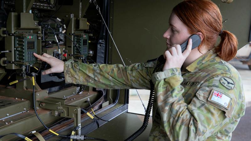 Air battle manager Flying Officer Kim Petterson performs start-up checks on a G-Wagon Command Post Module.