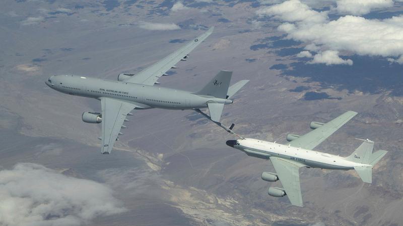 A RAAF KC-30A Multi-Role Tanker Transport from No 33 Squadron (left) conducts air-to-air refuelling trials with a USAF Boeing RC-135. 