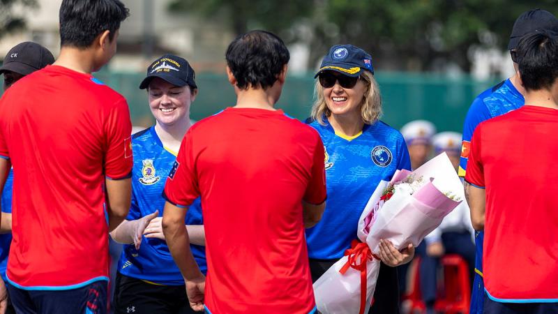 Members from HMAS Toowoomba shake hands with members from the Vietnamese Naval Technical College after playing volleyball during Indo-Pacific Endeavour 2023. 