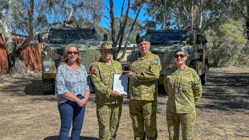 Major General David Thomae presents Warrant Officer Class Two William "Bob" Parsons with his third Federation Star and seventh clasp to the Defence Long Service Medal at the Puckapunyal Military Area.