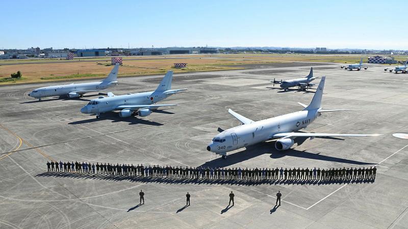  Crews and support personnel at NAF Atsugi base in Japan during Exercise AnnualEx 2023. Behind them are a RAAF P-8A Poseidon, left, Japan Maritime Self-Defense Force P-1, centre, Royal Canadian Air Force CP-140 Aurora, mid-ground, and United States Navy P-8 Poseidon, right. 