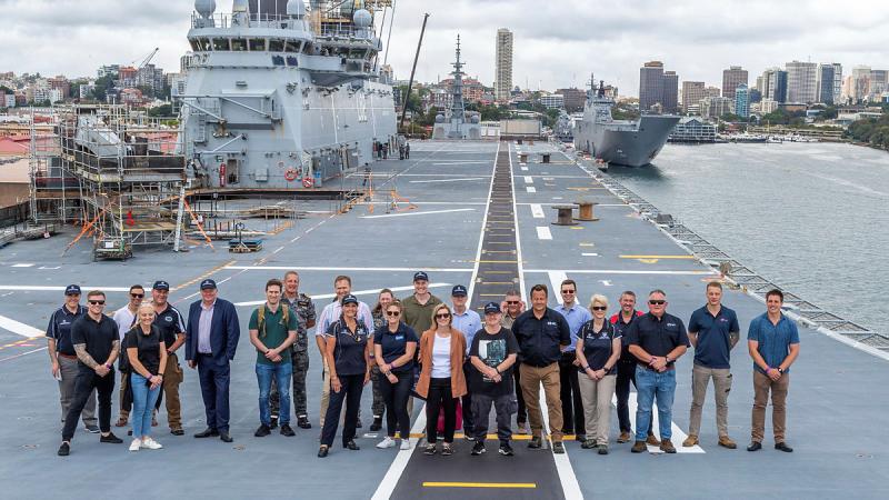 Employers and ADF Reservists pose for a group photo on the flight deck of HMAS Canberra during an immersion activity at Garden Island for the National Employer Support Awards in Sydney. 