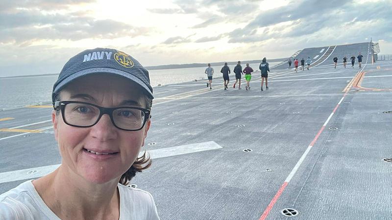 Defence Media adviser Felicity Jevardat de Fombelle on the flight deck of HMAS Adelaide for physical training at 6am, as part of the ship’s sea ride experience.