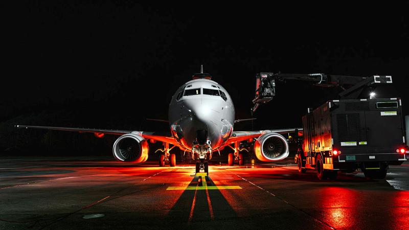 Personnel from 2 Squadron operate an aircraft de-icing machine to remove ice and snow from an E-7A Wedgetail before flight during Operation Kudu in Germany. 