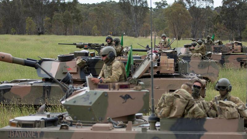  Australian Army soldiers prepare for a combat team quick attack with M1A1 Abrams and M113AS4 Armoured Personnel Carriers during Exercise Iron Warrior 23 at Puckapunyal. 