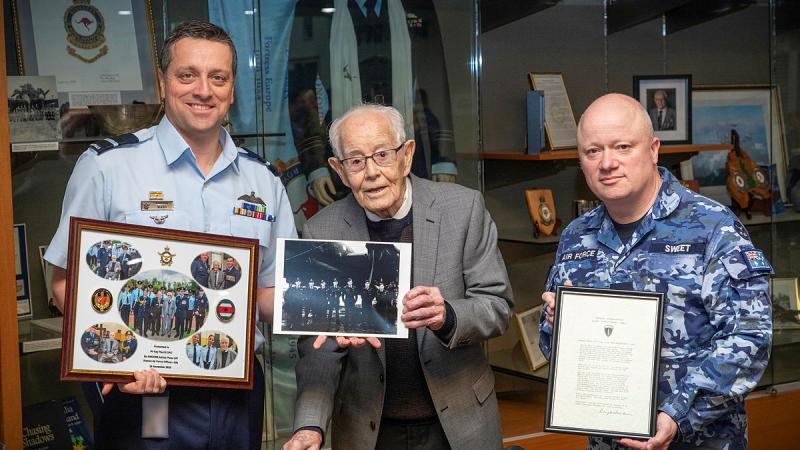 Centre, WW2 Bomber Command Veteran Ray Merrill, with a photo of his crew from WWII, Commander Air Warfare Centre, Air Commodore Adrian Maso with a memento for Mr Merrill, and RAAF Base Edinburgh Officers’ Mess Committee President Wing Commander Mark Sweet with the General Eisenhower signed letter at the RAAF Base Edinburgh Officers’ Mess.