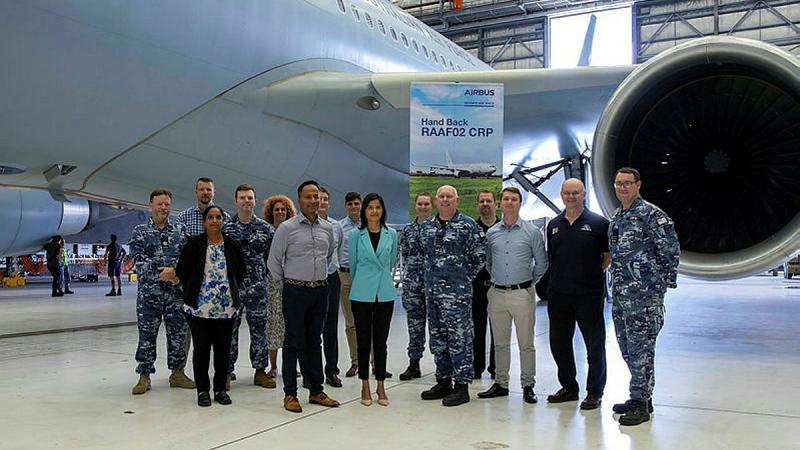 CRP Project Manager Akilan Krishnamoorthy (front row second from the left), Director PMU Noorin Popat (front, third from the left), and Group Captain Russell Barton (front, fourth from the left), with other team members and the first KC-30A to have returned from Spain after the upgrade.