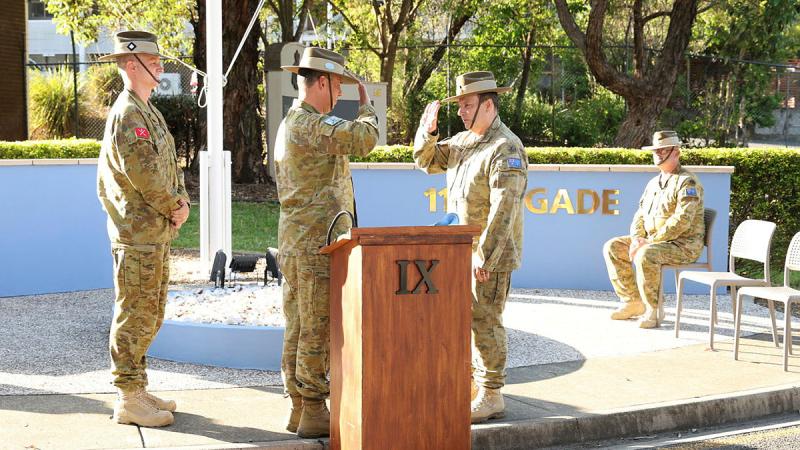 Outgoing Brigade Commander, Brigadier Mark Armstrong salutes Commander 2nd (Australian) Division, Major General Thomae, while incoming Brigade Commander Brigadier Richard Peace looks on, at the 11th Brigade Change of Command ceremony.