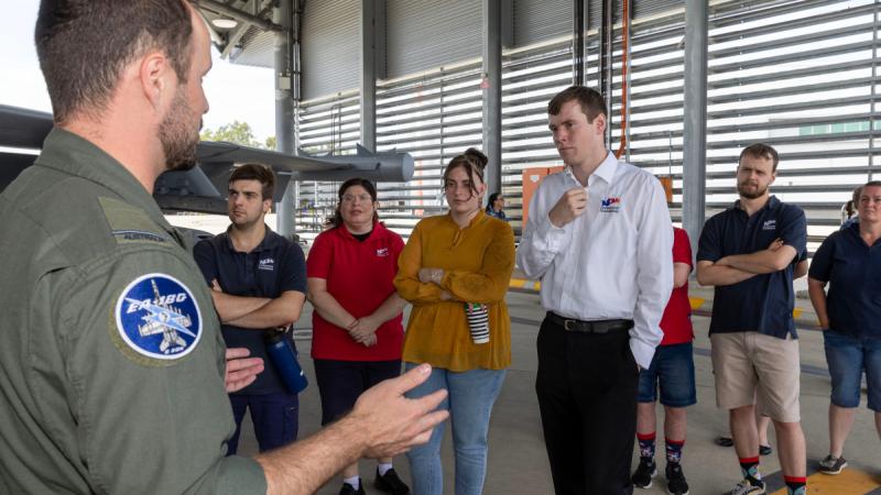 Flying Officer Mathew Schmidt speaks with members from the Amberley Defence Assistance Program during a visit to 6 Squadron at RAAF Base Amberley, Queensland.