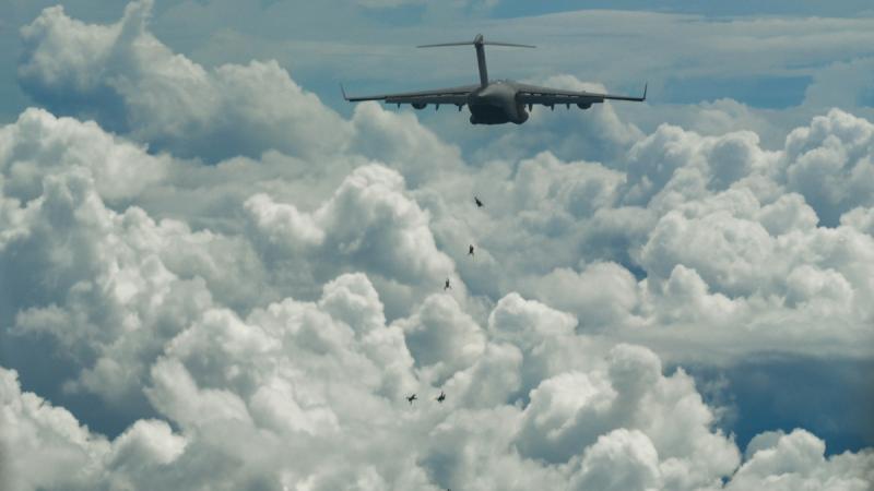 Members of Australian Army's 2nd Commando Regiment conduct a military free-fall parachute jump from a RAAF C-17A Globemaster III aircraft to commemorate the 80th anniversary of the Nadzab Landings in September 1943.