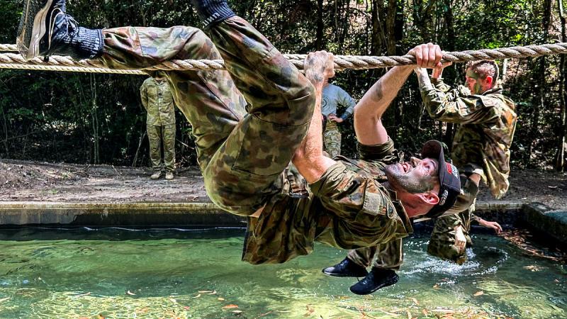 V8 Supercars crew from Matt Stone Racing traverse ropes during the Army obstacle course at Kokoda Barracks, Canungra. 