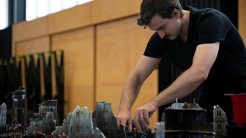 A member of the ADF Wargaming Association takes part in a Warhammer 40k battle during HeroCon23 at the Australian Defence Force Academy. 