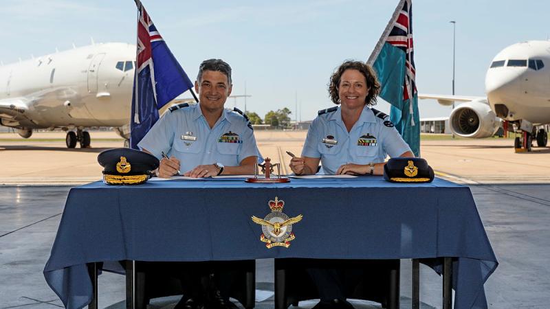 Outgoing commander Surveillance and Response Group Air Commodore Nathan Christie (left) and incoming commander Air Commodore Louise Desjardins sign the acceptance of command certificates. 