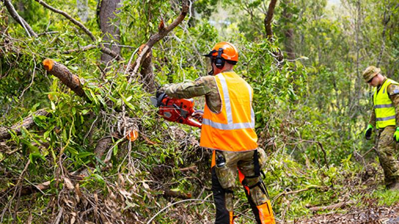 Australian Army soldiers from 11th Brigade clear tree debris in assisting the clean up effort at Coomera.