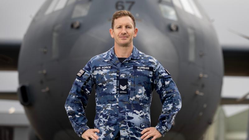 Australia Day Award recipient Sergeant Justin Kurban, an aviation technician, stands in front of aircraft at RAAF Base Richmond.